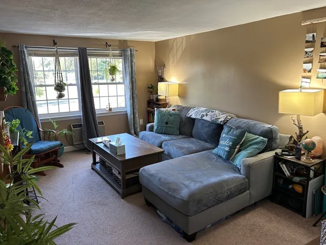 a living room with furniture and a lamp