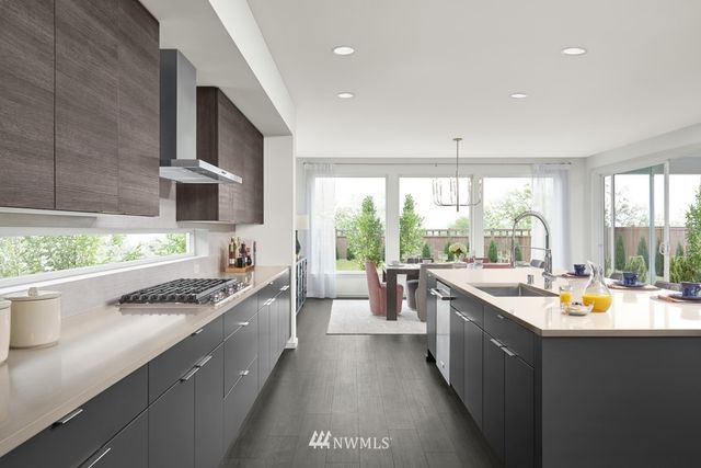 a kitchen with stainless steel appliances a sink stove and cabinets