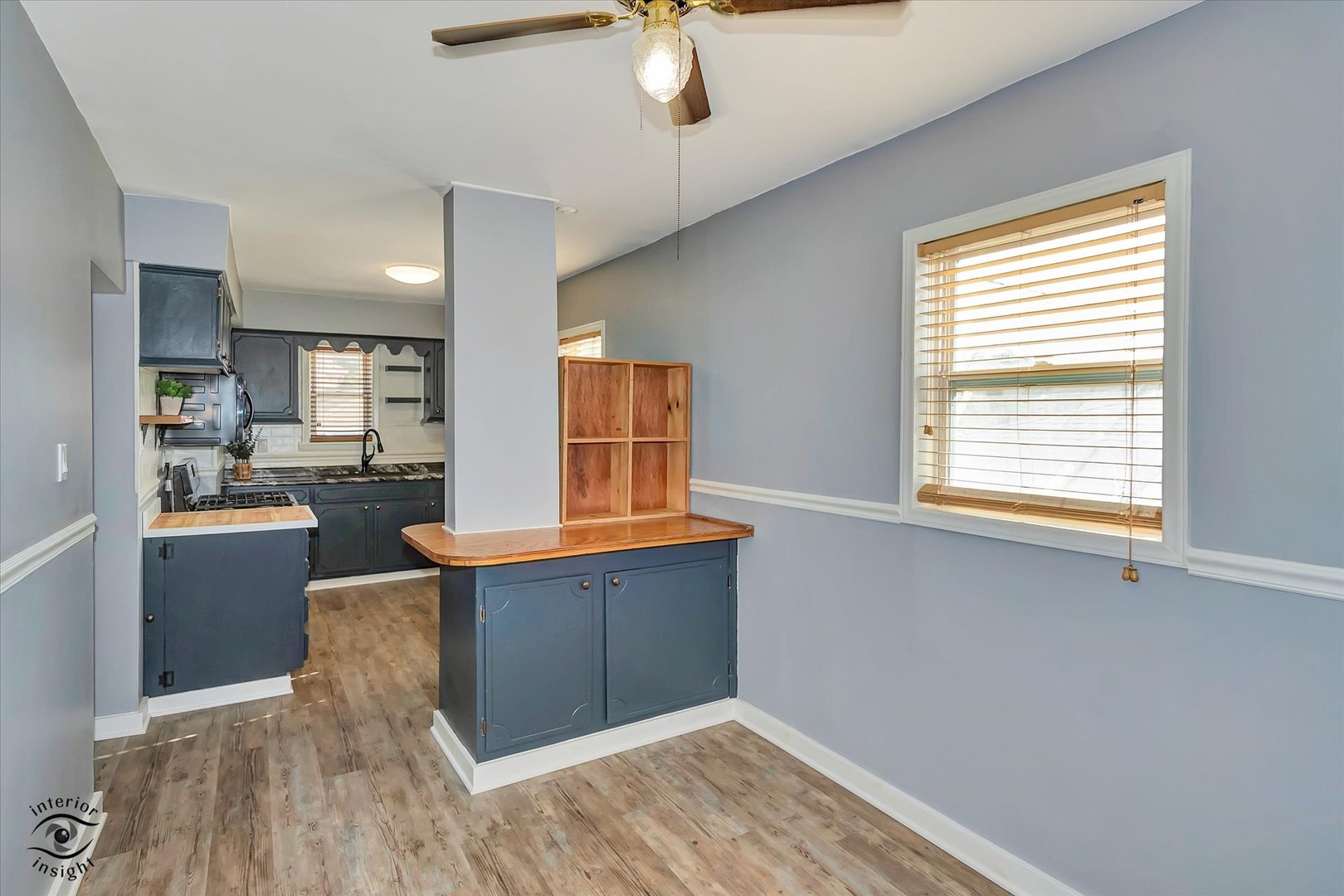 7515 West 61st Street Summit, IL 60501 - Photo 12 of 32 a kitchen with stainless steel appliances wooden floor and a window