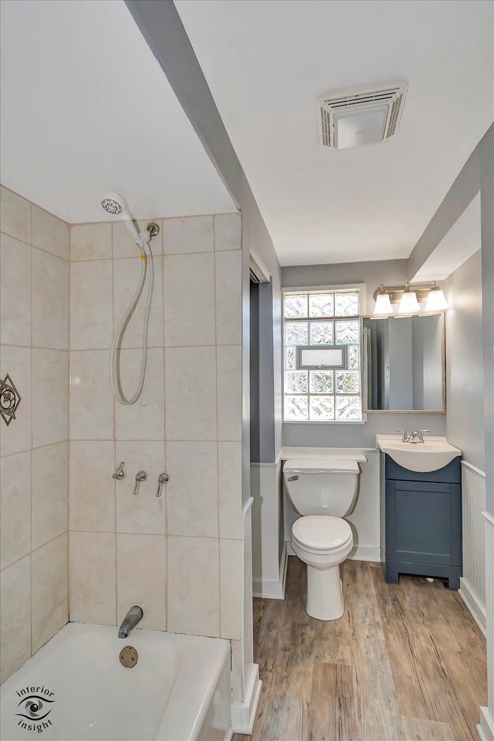 7515 West 61st Street Summit, IL 60501 - Photo 16 of 32 a bathroom with a shower a toilet and sink