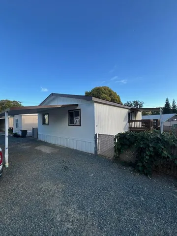a view of a house with a backyard