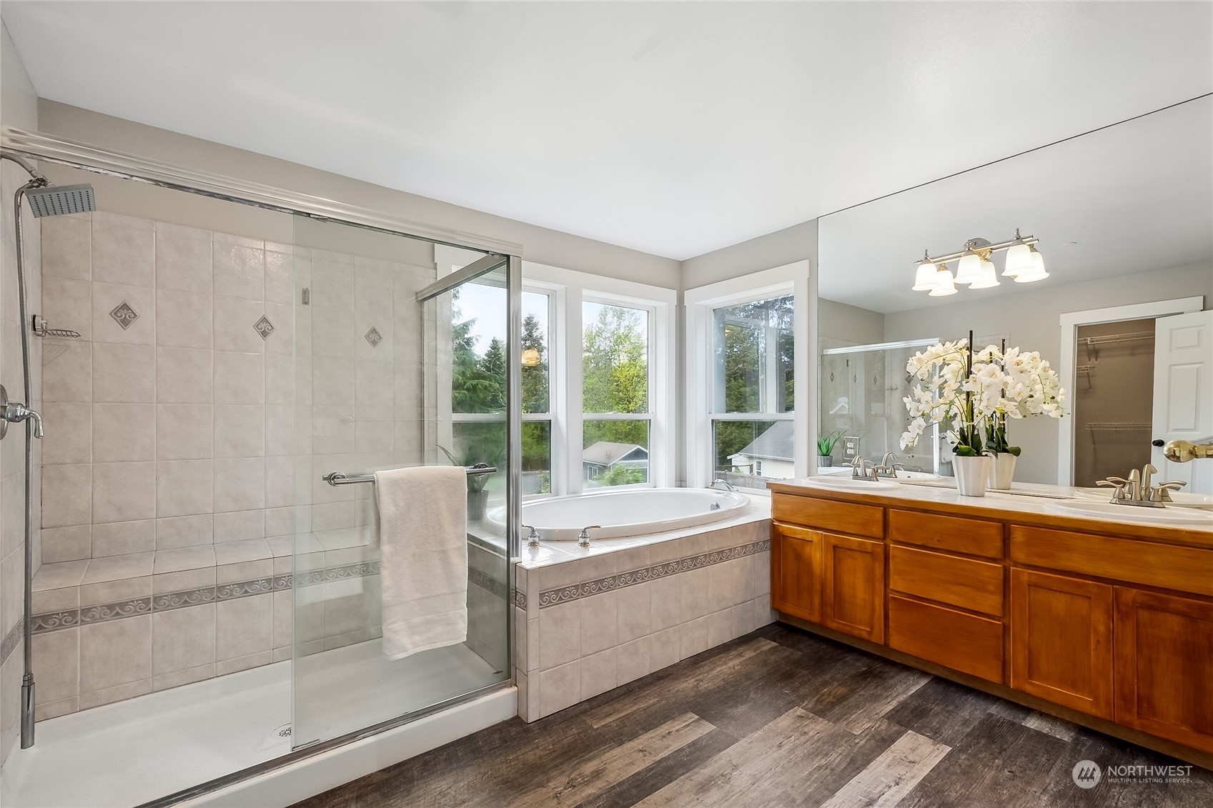 24827 247th Place Southeast Maple Valley, WA 98038 - Photo 19 of 33 a bathroom with a tub sink shower and mirror