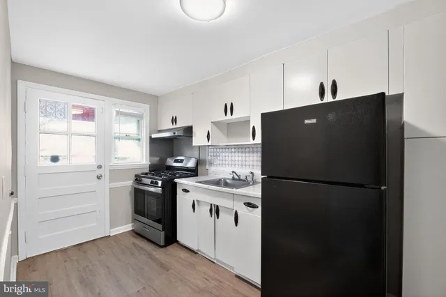 a kitchen with a refrigerator stove and sink
