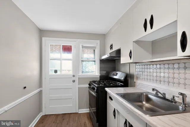 a kitchen that has a sink and a stove