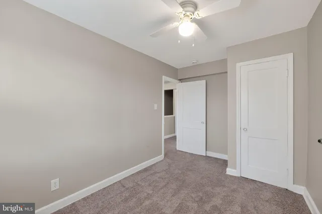 a view of an empty room with a fan