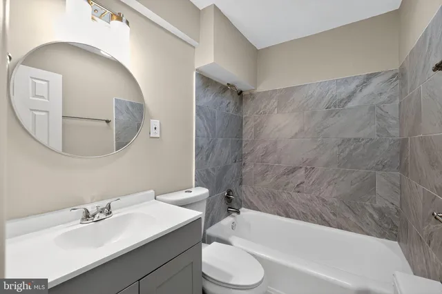 a bathroom with a sink toilet and bathtub