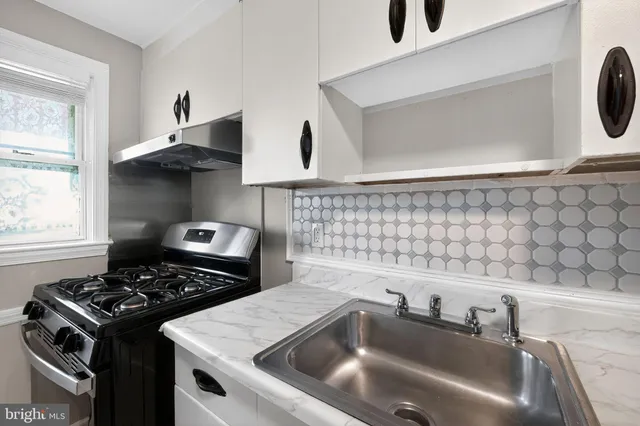 a kitchen with a stove and a sink