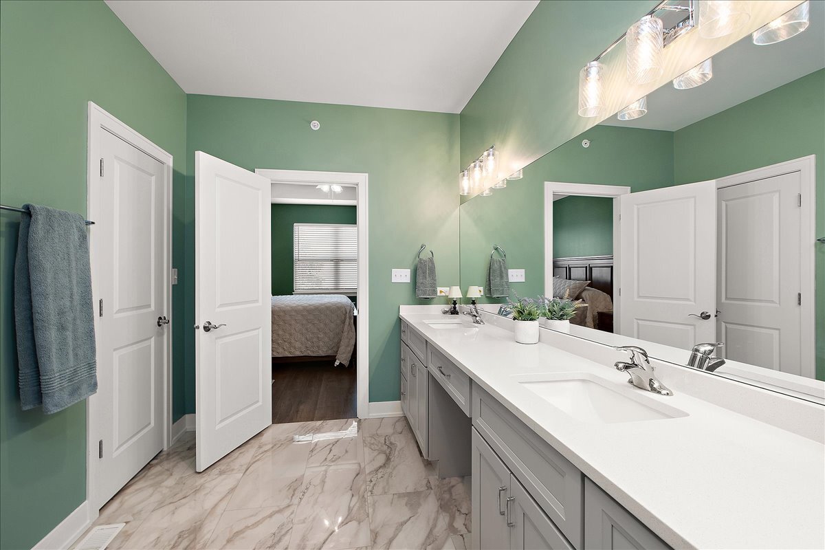 1330 Lacoma Drive Lockport, IL 60441 - Photo 17 of 36 a en suite bathroom with a double vanity sink and a mirror