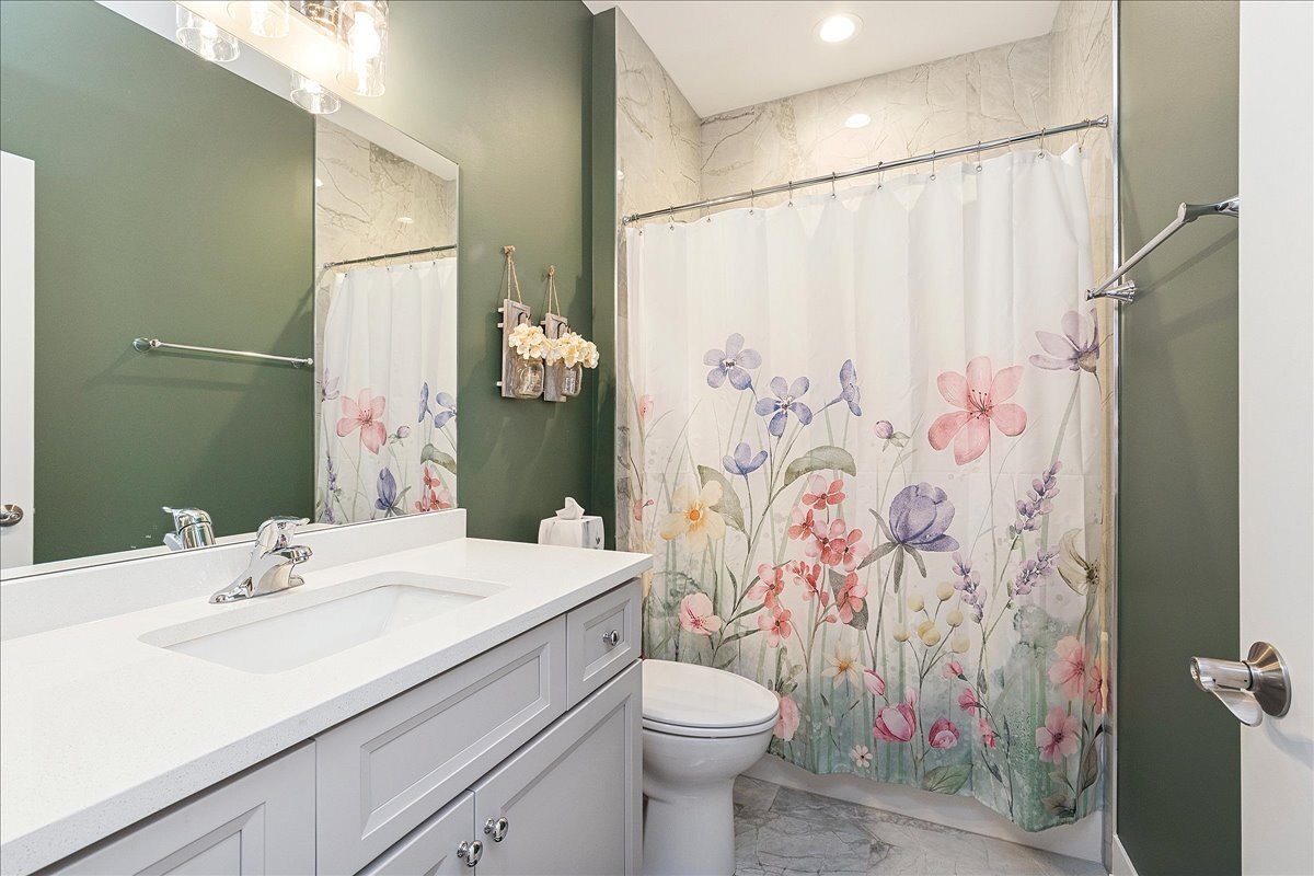 1330 Lacoma Drive Lockport, IL 60441 - Photo 20 of 36 a bathroom with a sink a toilet and shower curtain