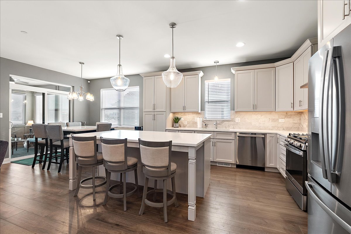 1330 Lacoma Drive Lockport, IL 60441 - Photo 7 of 36 a kitchen with a dining table chairs sink and cabinets