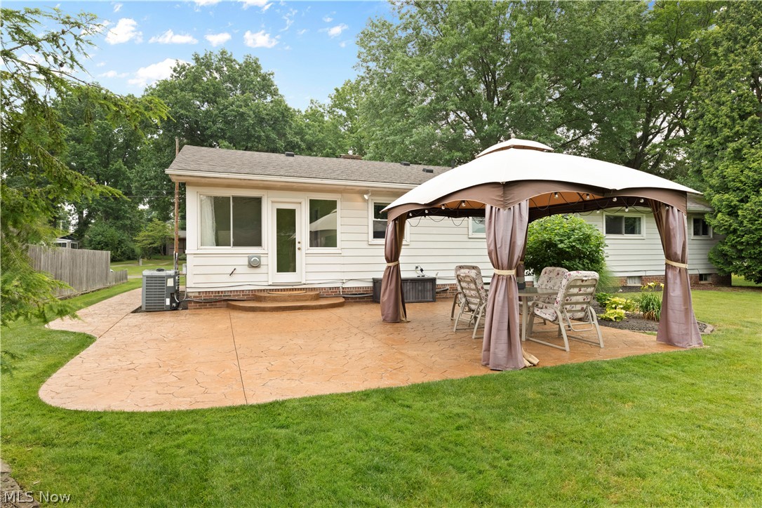 575 Overwood Road Akron, OH 44313 - Photo 31 of 45 Back of house featuring a patio, a lawn, central air condition unit, and a gazebo