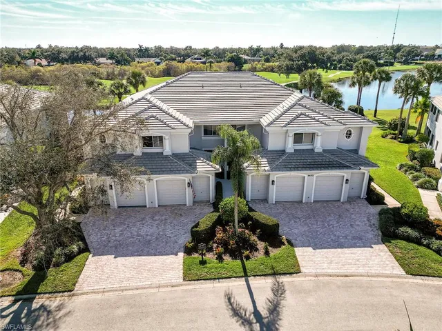 a front view of a house with a garden and plants