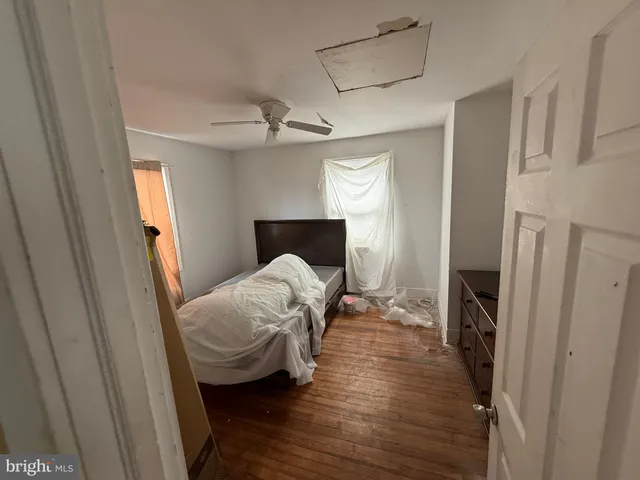 a bedroom with a bed and a mirror