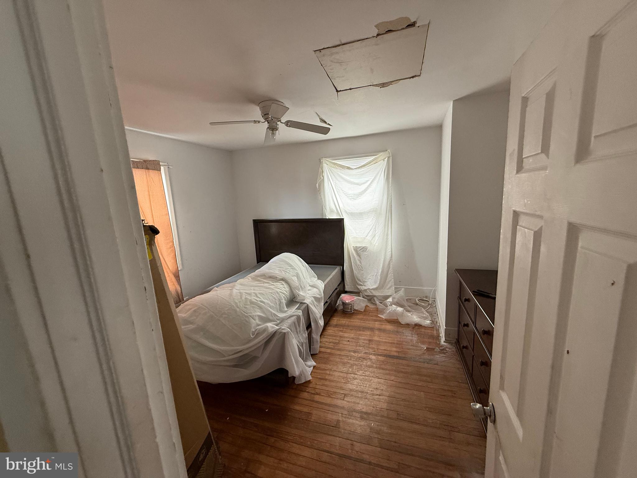 23 East Mowry Street Chester, PA 19013 - Photo 8 of 18 a bedroom with a bed and a mirror