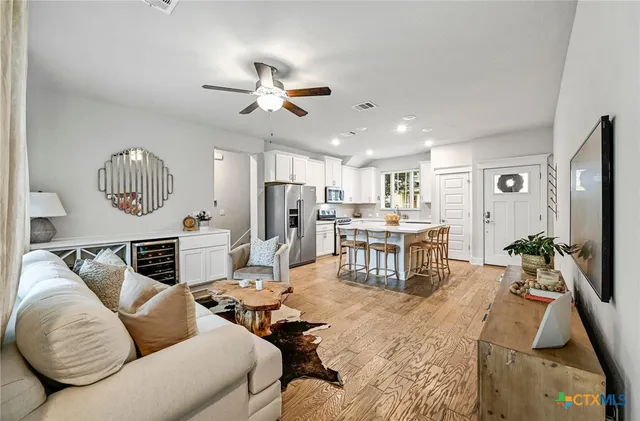 a living room with furniture ceiling fan and a rug