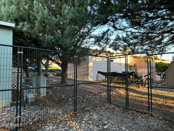 a view of terrace with lawn chairs and iron fence