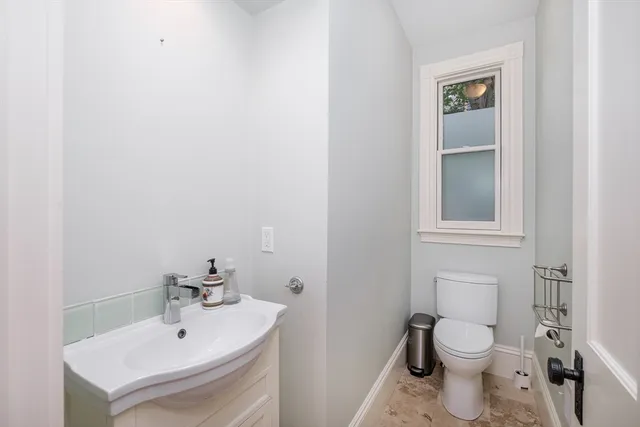 a bathroom with a sink toilet and vanity