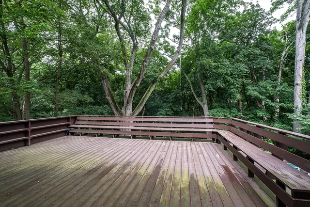 a view of deck with two chairs and wooden floor