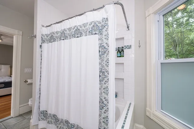 a bathroom with a shower and a mirror