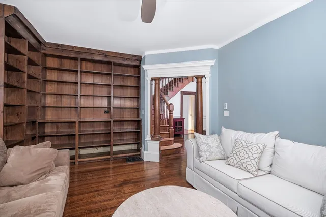 a living room with furniture and wooden floor