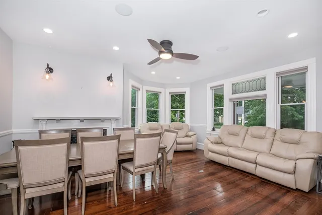 a living room with furniture dining table and a large window