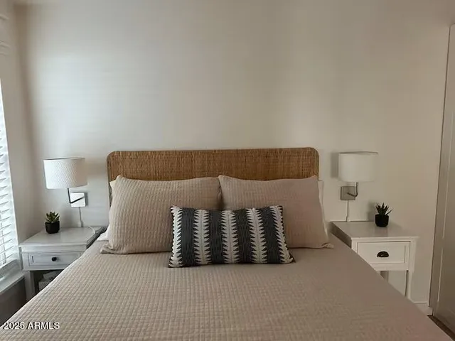 a bedroom with a bed and a lamp