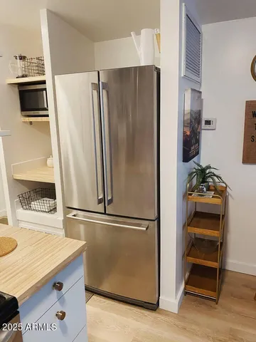 a kitchen with a refrigerator and a stove top oven