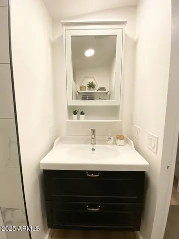 a bathroom with a sink a mirror and a vanity