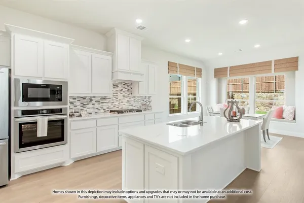 a kitchen with stainless steel appliances kitchen island granite countertop a sink and cabinets