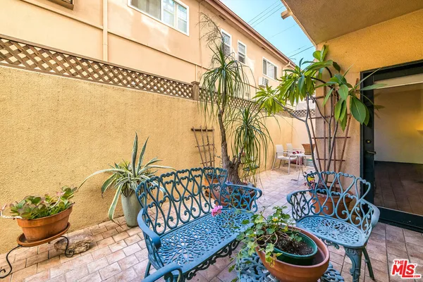a backyard of a house with barbeque oven table and chairs