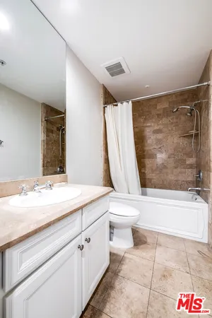 a bathroom with a sink a toilet and bathtub