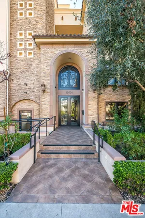 a front view of a house with plants