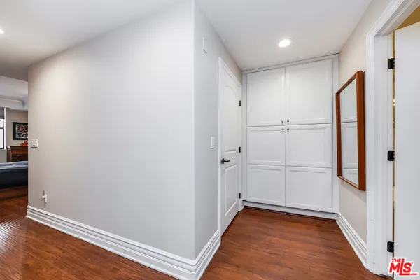a view of a hallway with wooden floor