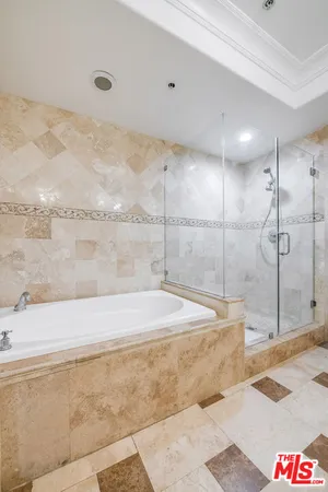 a bathroom with a tub and shower