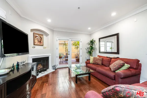 a living room with furniture fireplace and a flat screen tv