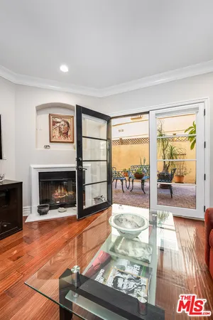 a living room with fireplace furniture and a floor to ceiling window