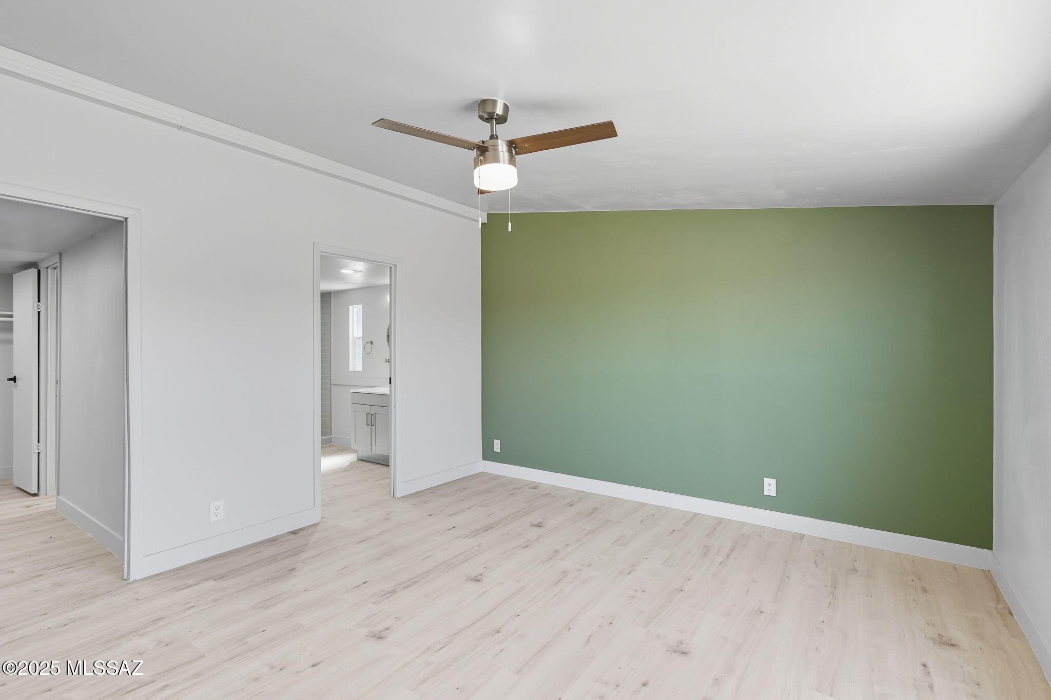8790 North Trico Road Marana, AZ 85653 - Photo 13 of 35 an empty room with wooden floor and a ceiling fan