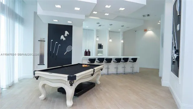 a kitchen with a sink and chairs