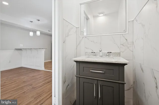 a view of an empty room with wooden floor and closet