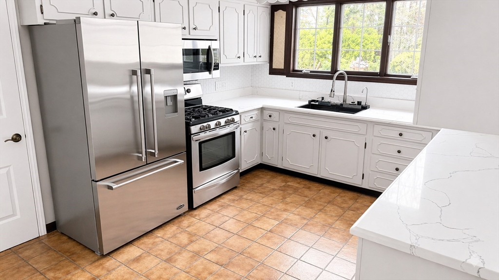 12 Woodland Road Westfield, MA 01085 - Photo 11 of 29 a kitchen with stainless steel appliances a refrigerator sink and cabinets