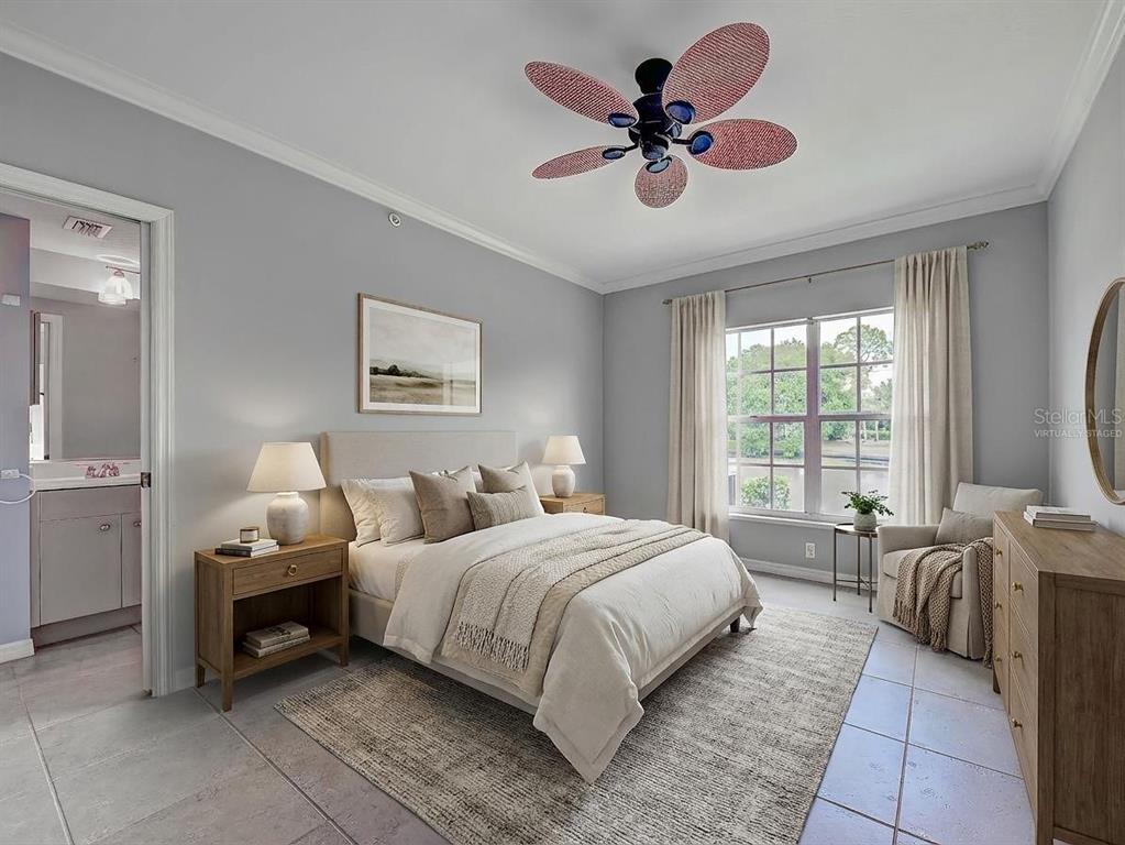902 Addington Court, Unit 103 Venice, FL 34293 - Photo 19 of 48 a bedroom with a bed a chandelier and a window
