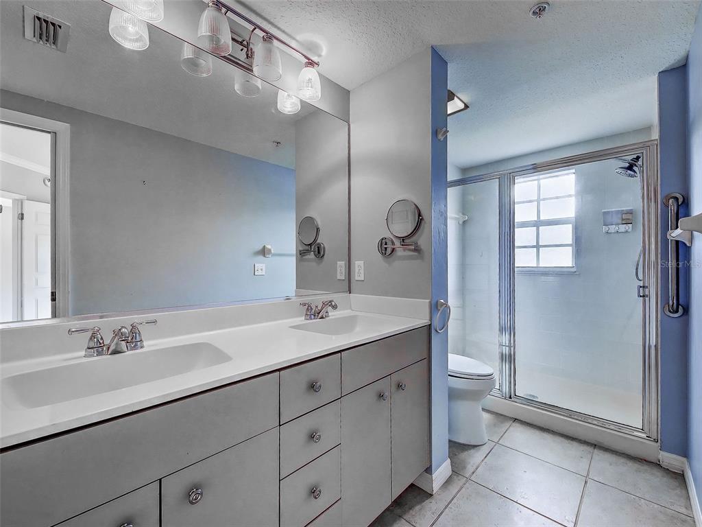 902 Addington Court, Unit 103 Venice, FL 34293 - Photo 24 of 48 a bathroom with a sink double vanity and a mirror