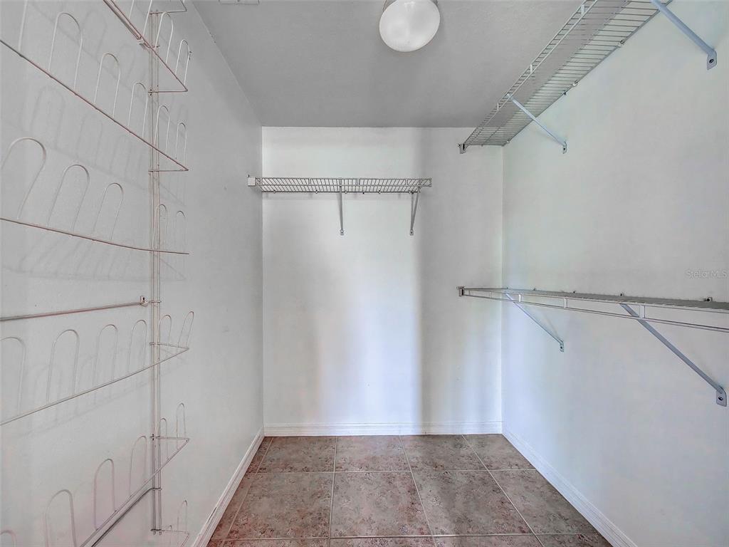 902 Addington Court, Unit 103 Venice, FL 34293 - Photo 26 of 48 a view of a room with racks on the wall