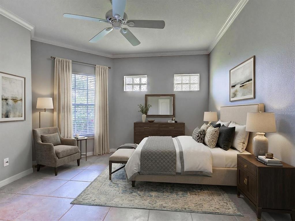 902 Addington Court, Unit 103 Venice, FL 34293 - Photo 27 of 48 a bedroom with a bed a couch and windows