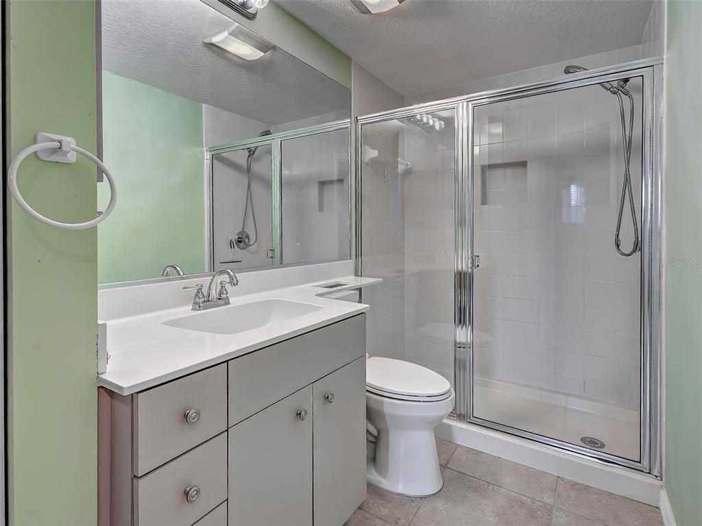 902 Addington Court, Unit 103 Venice, FL 34293 - Photo 29 of 48 a bathroom with a sink toilet and shower