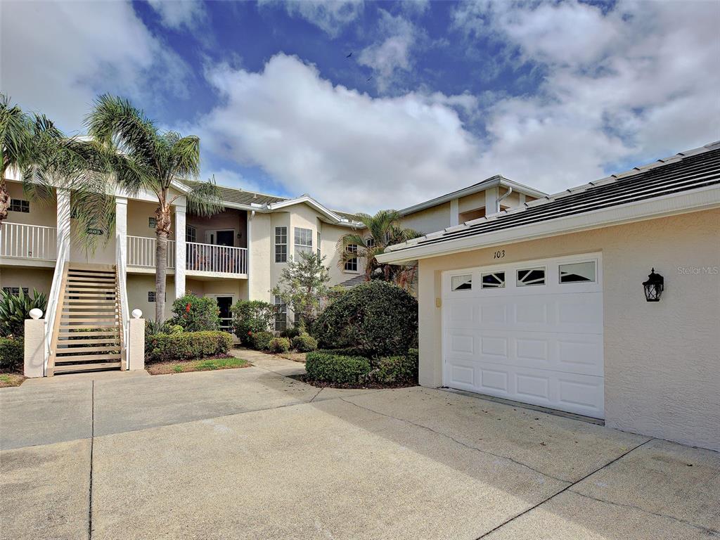 902 Addington Court, Unit 103 Venice, FL 34293 - Photo 3 of 48 front view of a house with a yard