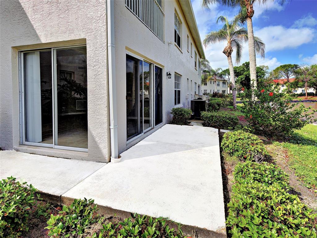 902 Addington Court, Unit 103 Venice, FL 34293 - Photo 34 of 48 a view of a potted plants in front of a building