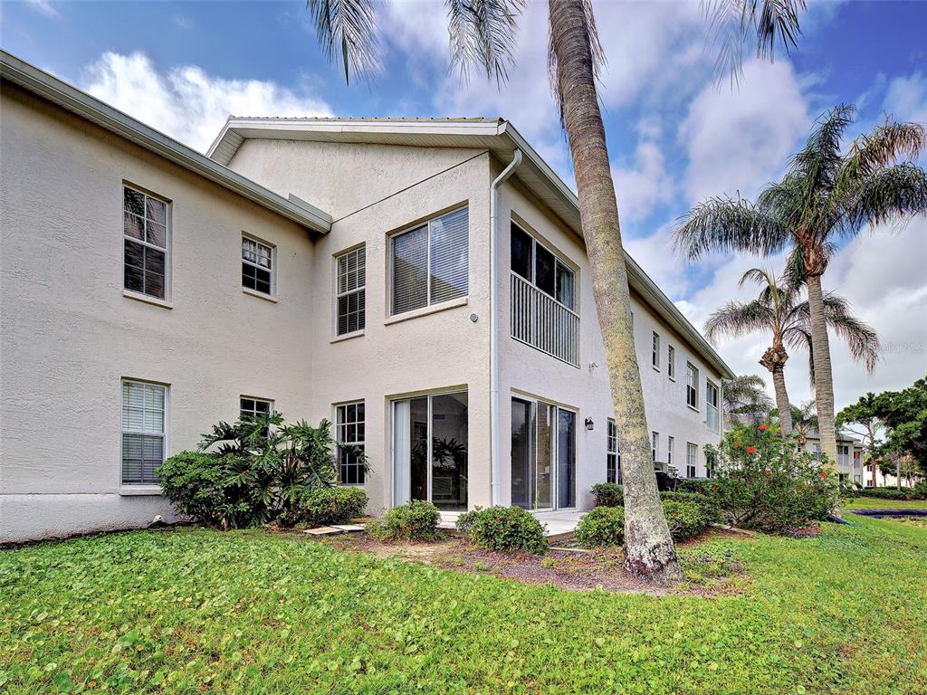 902 Addington Court, Unit 103 Venice, FL 34293 - Photo 35 of 48 a front view of a house with a yard