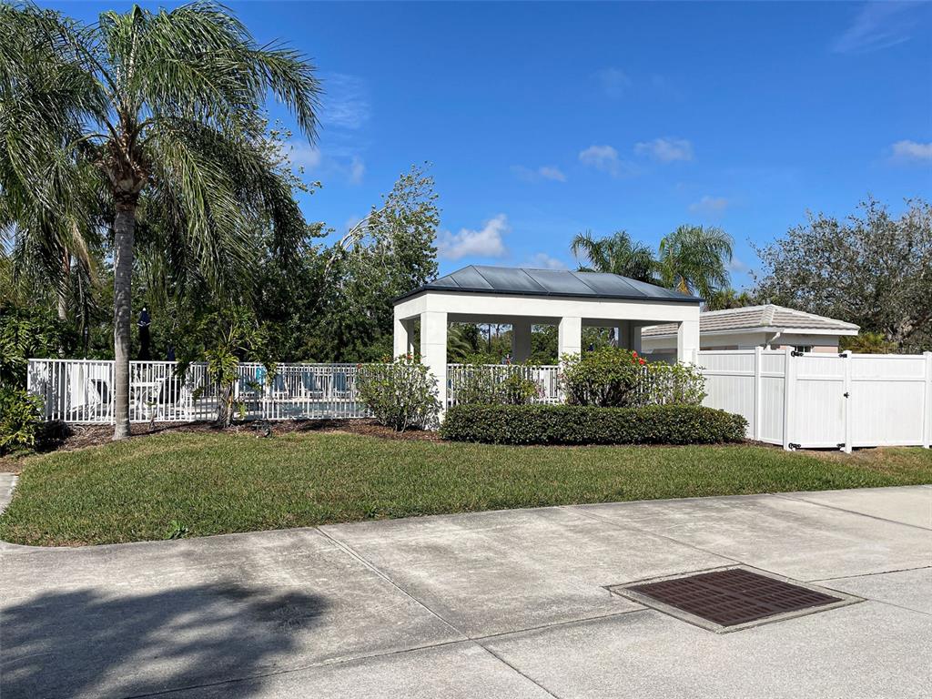 902 Addington Court, Unit 103 Venice, FL 34293 - Photo 42 of 48 a front view of a house with a garden
