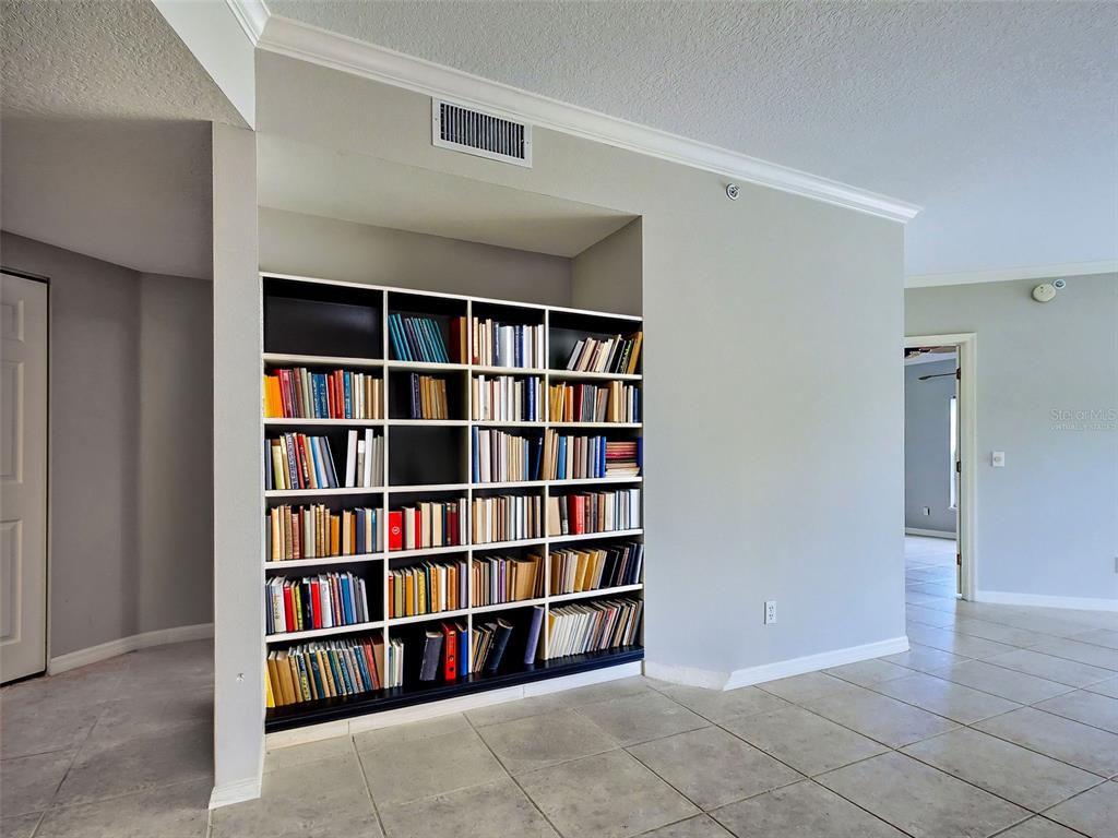 902 Addington Court, Unit 103 Venice, FL 34293 - Photo 9 of 48 a view of a book shelf in a room